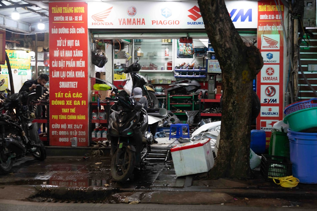 Motorcycle parts store with many motorcycles outside.